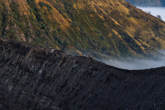 People standing on Mount Bromo crater at sunrise in Java Indonesia