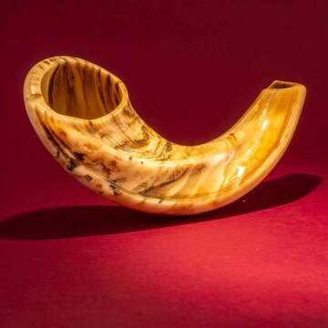 Traditional Shofar on Red Background.
