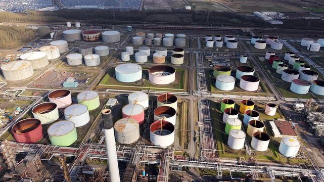 Aerial view of Lindsey Oil Refinery's tanks, a sprawling industrial landscape, where a symphony of cylindrical forms creates a mesmerizing pattern, Immingham, United Kingdom.
