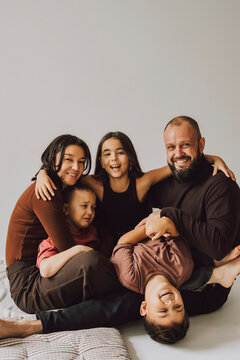 Happy family playing and hugging together at home