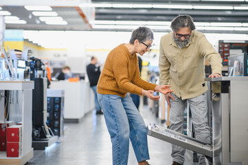 Fototapeta premium Mature couple shopping for a new dishwasher