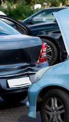 Car accident scene with damaged vehicles on a busy street in broad daylight