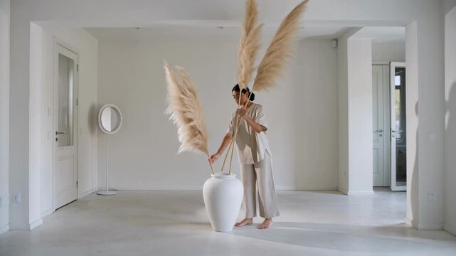 Captivating dance with pampas grass in a serene white space captures the beauty of nature and art