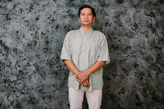 Portrait of Calm Asian Man in Traditional Style Shirt