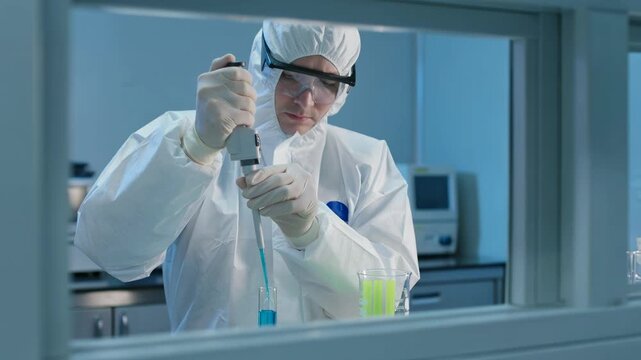 Researcher in protective suit processing fluorescent reagents with precision pipette in sterile lab