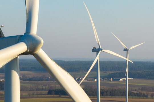 Aerial view of wind turbines standing tall against the horizon, harnessing the wind's energy, Stawiski, Podlaskie Voivodeship, Poland.