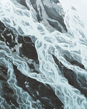 Aerial view of glacial rivers carve intricate patterns through the dark volcanic landscape, creating a stunning contrast of icy blues and stark blacks, Skaftarhreppur, Iceland.