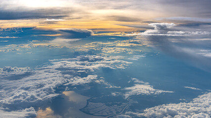 Beautiful aerial landscape featuring dramatic cloud formations and warm sunlight during the golden...