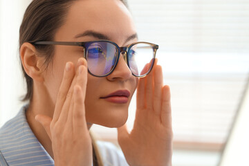 Fototapeta premium Female trader in eyeglasses working at office, closeup