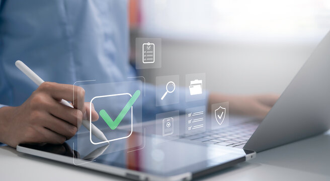 Business person using tablet with digital checklist interface and green check mark. Online task management quality control document verification workflow approval and business compliance concept
