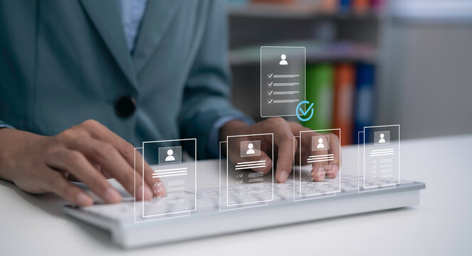 Businesswoman typing on keyboard with digital HR interface showing candidate profiles and checklist verification. Recruitment technology, employee selection, hiring process and HR management system