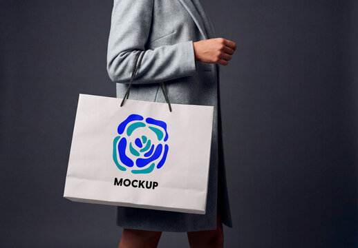 Woman Carrying Grey Paper Shopping Bag