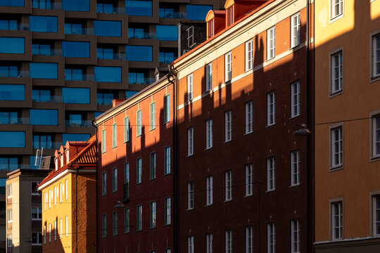 Colorful residential street facades in Stockholm Sweden with architecture shaped by sunlight shadows and urban geometry during bright daylight