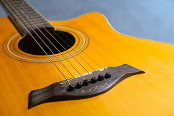 Fototapeta premium Acoustic guitar on gray background.