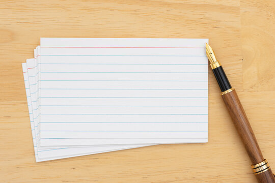 Stack of index cards with fountain pen on desk