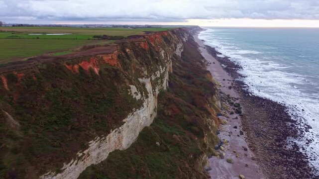 Drone flying along the coastline, cliffs , on the Alabaster coast, Saint-Jouin-Bruneval beach, Normandy in France. Aerial sideways