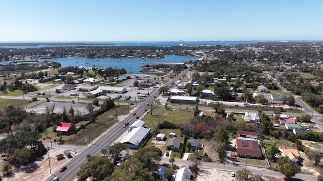 Panoramic drone fly of coastal settlement with residential houses and inland lagoon behind Gulf community, 30A, Florida, USA