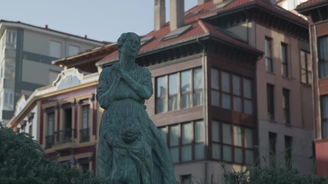 Historic statue standing in a public square surrounded by traditional buildings in Cand&aacute;s, Asturias, Spain. Cultural landmark reflecting the heritage and architecture of this coastal town in Spain