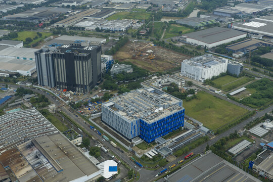 Aerial view of modern data center buildings with ai and industrial area, showing urban development and digital infrastructure, Jakarta, Indonesia.