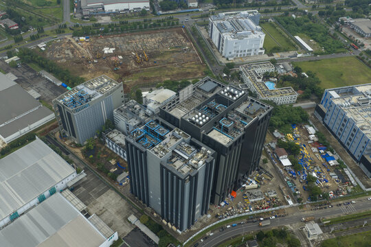 Aerial view of data center buildings with rooftop infrastructure, showing industrial area development and technology infrastructure, Jakarta, Indonesia.