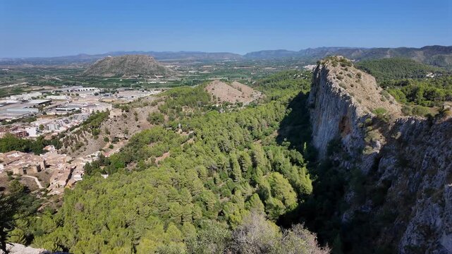 Xativa Castle view point from the walls of the iconic fortress and historic prison. Mountainous cliffs and ridges jet out of the valley as the valley is seen below. Xativa castle is cliff side castle