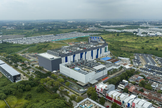 Aerial view of large modern ai data center building facility with cooling units on roof. Digital technology infrastructure, Jakarta, Indonesia.