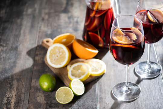 Sangria cocktail with fresh fruit on wooden table. Copy space