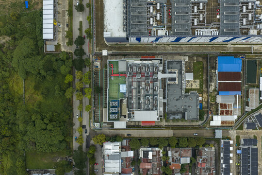 Aerial view of a large modern datacenter complex, showing rooftop cooling systems and facilities, Jakarta, Indonesia.