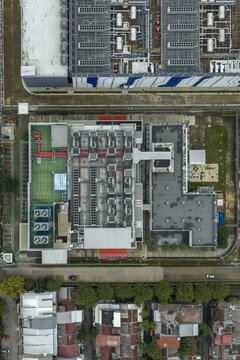 Aerial view of a modern datacenter infrastructure building, next to residential areas, Jakarta, Indonesia.