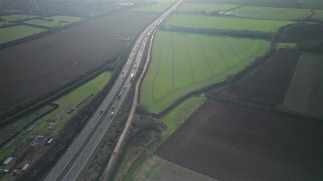 Aerial View of A12 Motorway Traffic Passing Through Rural Essex Countryside, England