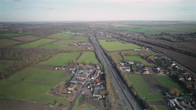 Aerial Drone View of A12 Motorway Running Through Essex Countryside and Villages, England