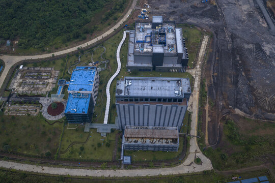 Aerial view of a large modern ai data center developing, featuring multiple buildings, green spaces, and a construction site, Kuala Lumpur, Malaysia.