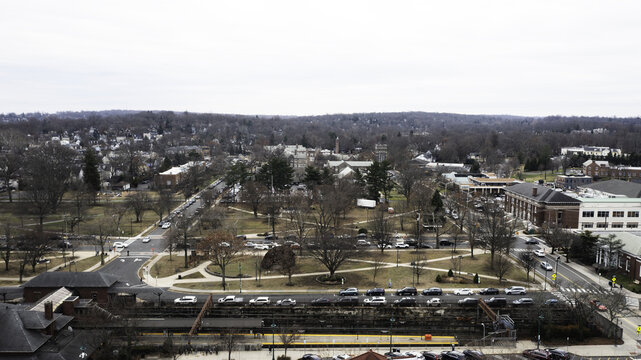 Aerial view of a town square with bare trees casting long shadows on the frosted grass, cars lining the streets, Summit, New Jersey, United States.