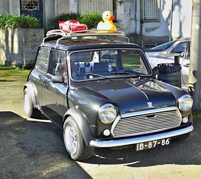 Mini Cooper classic car with roof rack and toys