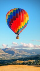 Fototapeta premium Colorful Balloon Adventure Over Scenic Highland Meadows with Clear Blue Sky and Vibrant Rainbows