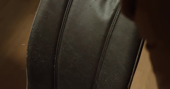 Close-up of a damaged chair with torn fabric likely caused by a pet such as a cat or dog. Concept of pet behavior, scratched furniture, household damage, and pet ownership.