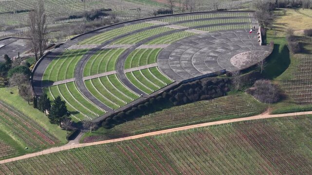 Aerial view of the French military cemetery with rows of white headstones contrasting with green grass, Mittelwihr, Grand Est, France.