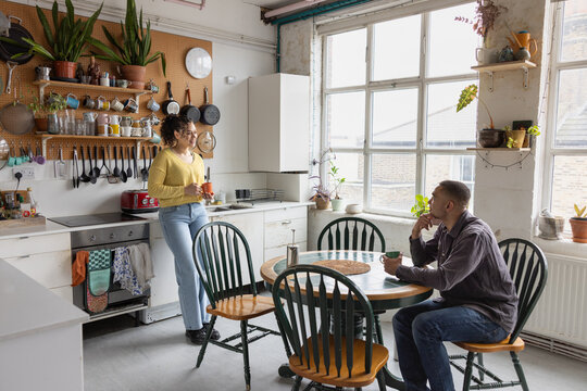 Roomies hanging out together in a kitchen