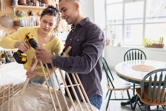 Young Couple Building a DIY Project Together in Kitchen