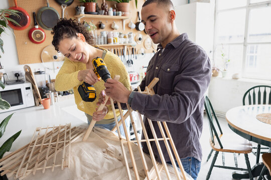 Friends repairing a piece of furniture together