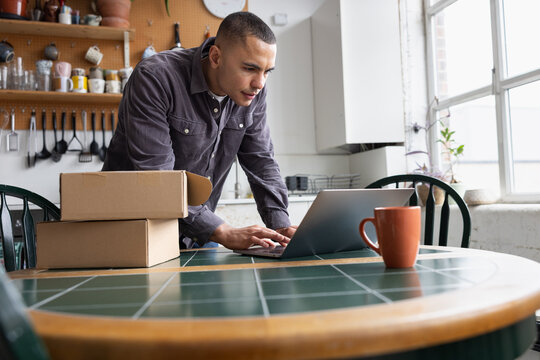 Focused man getting a parcel ready to ship