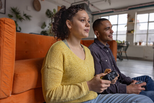 Gaming Together on Couch, Laughing and Smiling