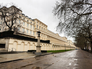 Naklejka premium London, UK street view of grand beige Carlton House Terrace row with lampposts and bare trees