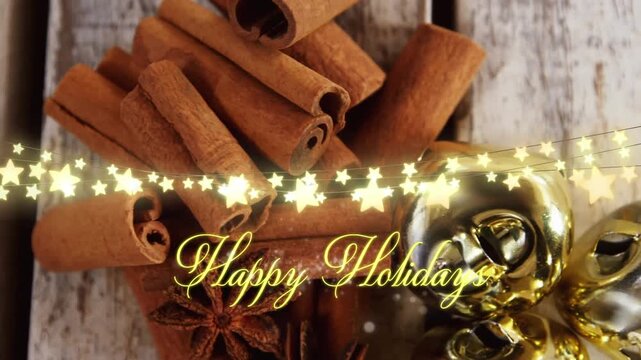 Animation of text, happy holidays, in yellow, over string lights, decorations and cinnamon sticks