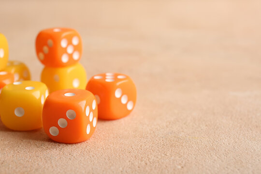Different dices on beige background