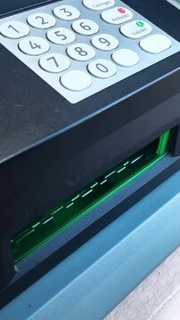 Withdrawing euro banknotes from ATM cash machine in Europe