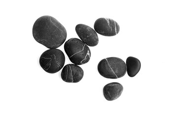 Black pebble stones arranged on a white background showcasing various shapes and sizes, highlighting their smooth surfaces and natural textures for decorative purposes