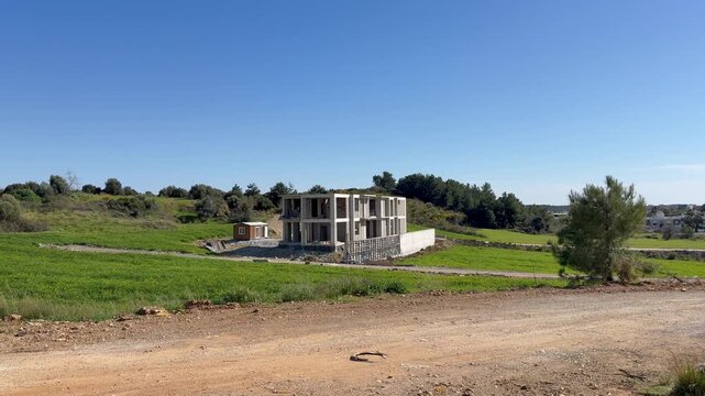 The new building under construction is a detached house.
