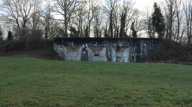 Maastricht 2 Casemate Bunker At Fort Eben-Emael In Belgium. Surrounded By Leafless Winter Trees On Grassy Hillside. wide shot