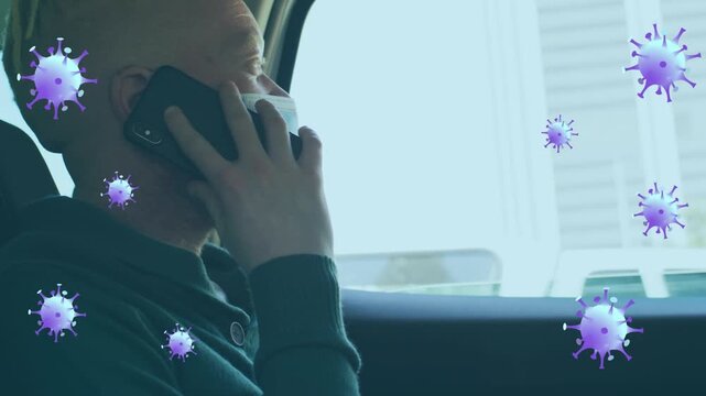 Animation of virus cells over albino african american businessman talking on smartphone